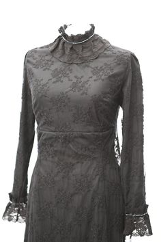 Introducing Eleanor - the Cotton Lace Black Dress - the perfect embodiment of an Edwardian style dress with a modern twist. Made from high-quality cotton, this dress boasts intricate embroidered lace that adorns its cuffs and delicate details in the high collar neck.  This dress features a unique train detail that adds an air of sophistication and elegance to your look. The long sleeves are also accented with lace, creating a timeless design that is ideal for any formal occasion. The high waiste Spring Gothic Lace Dress, Gothic Lace Patchwork Dress, Gothic Lace Dress For Halloween, Fall Lace Dress With Lace Collar, Long Sleeve Vintage Dress For Halloween, Gothic Dresses With Lace Trim For Evening, Gothic Evening Dresses With Lace Trim, Gothic Lace Trim Dresses For Evening, Black Long Sleeve Dress With Lace Work