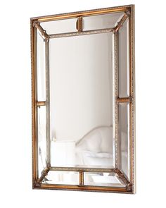 a mirror that is sitting on top of a wall