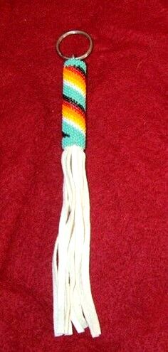 a key chain with a multicolored tassel hanging from it's end