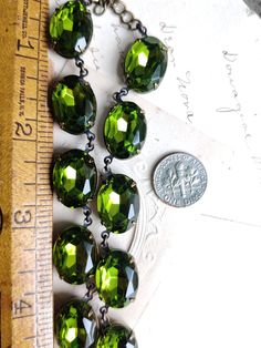 "Lovely green olivine oval stones are like a ring of crystallized mossy green forest around your neck. Each stone hand set and hand linked with high quality findings. Made to last a lifetime. Adjustable from 16 to 18\" with lobster claw and extender. stones are 18x13mm Beautiful for layering. Inspired by georgian collets. Gift boxed Find more to layer here : Www.sacredcake.etsy.com" Elegant Green Oval Bead Necklaces, Elegant Green Necklaces With Oval Beads, Elegant Green Oval Beaded Necklaces, Faceted Green Oval Beaded Jewelry, Vintage Green Crystal Jewelry, Elegant Green Oval Beads Jewelry, Green Oval Jeweled Jewelry, Green Crystal Necklace With Stones, Vintage Green Oval Beads Jewelry