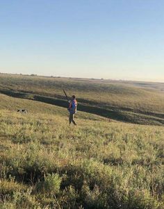 a man standing on top of a lush green field