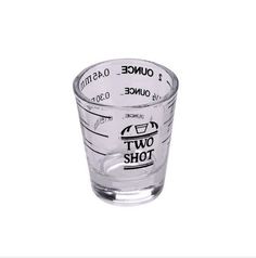 a shot glass filled with liquid on top of a white background, that says 1 ounce