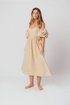 The Hamilton is everything you're looking for in a midi dress - charming, sophisticated, and absolutely flattering. It features premium quality details, like a sweetheart neckline and gorgeous balloon sleeves that can be worn on or off the shoulder. It's an unforgettable choice for every body type, and extra-comfy for expecting mamas! The best part? You can wear this beauty long after your sweet baby arrives! Available in multiple colorways. FIT: Runs true to size. Features a smocked back panel for comfort. This dress is roomy in the waist and will accommodate early maternity in your true size, but consider sizing up if you are in advanced pregnancy. MATERIAL: GARMENT DETAILS: Empire-waisted midi dress, with sweetheart neckline and statement balloon sleeves that can be worn on or off the s Chic Dress With Gathered Neckline For Brunch, Chic Brunch Dress With Gathered Neckline, Garden Party Puff Sleeve Dress With Ruched Bodice, Garden Party Dress With Puff Sleeves And Ruched Bodice, Spring Puff Sleeve Dress With Balloon Sleeves, Midi Dress With Ruched And Fitted Bodice For Brunch, Puff Balloon Sleeve Dress For Garden Party, Midi Length Dresses With Pleated Sleeves For Garden Party, Summer Brunch Puff Sleeve Dress With Balloon Sleeves