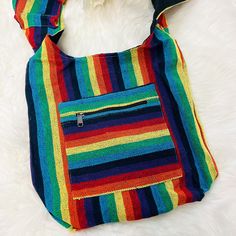 a multicolored purse sitting on top of a white furnishing covered floor