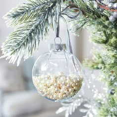 an ornament hanging from a christmas tree filled with balls and candy canes