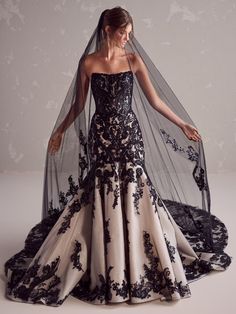 a woman in a black and white wedding dress