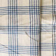 the blue and white plaid fabric has been folded up to show it's pattern