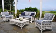 wicker patio furniture set with blue and white cushions