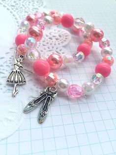 "Ballet party, Ballerina party, ballerina bracelet, ballerina jewelry, dance recital, ballet bracelet, ballet party favor. SET of TEN. Party planning is already so stressful. Leave the favors up to us! This listing is for (10) child sized bracelets. DETAILS and MEASUREMENTS: Beads vary in sizes from 6mm-10mm. The length of a bracelet is 6.5\" (we can make them smaller or bigger for you). COLOUR & CHARM CHOICES: If the bracelet does not match your party theme exactly, just send us a note. We love Adjustable Pink Charm Bracelet For Party, Pink Adjustable Charm Bracelet For Parties, Whimsical Adjustable Beaded Bracelets For Party, Pink Flexible Beaded Bracelets For Gifts, Pink Beaded Bracelets For Gift, Pink Adjustable Stretch Bracelet For Party Favors, Handmade Flexible Pink Bracelets, Pink Bracelet For Party Favors, Pink Handmade Stretch Bracelet For Party