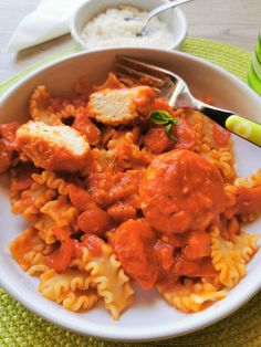 a white bowl filled with pasta and meatballs