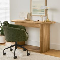 a desk with a chair, lamp and potted plant