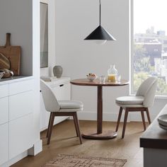 a dining room table with two chairs around it