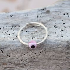 Pink eye, evil eye ring, open sterling silver ring 1.3 mm thick. Stackable ring. All our products are handmade in our little workshop with much care and love. You are welcome to send us a message if you have any questions! Best, Christina OPTION TO UPGRADE AT CHECKOUT WITH DHL Express FOR DELIVERY IN 3-5 DAYS Handmade Pink Toe Ring Jewelry, Handmade Pink Toe Ring, Handmade Pink Promise Ring, Nickel Free Pink Promise Ring, Pink Adjustable Toe Ring, Pink Stackable Midi Rings As Gift, Adjustable Pink Toe Ring, Pink Adjustable Open Midi Ring, Pink Adjustable Sterling Silver Stackable Rings