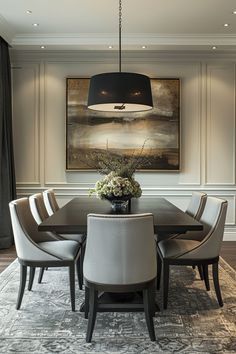 a dining room table with white chairs and a black chandelier hanging over it