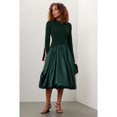 Green knit (83% Rayon, 17% Elastane; Combo: 70% Polyester, 30% Nylon). Lining (100% Nylon). A-line. Long sleeves. Crewneck. Pull on. 51.5" from shoulder to hemline. Imported. Evening Midi Dress With Voluminous A-line Skirt, Stretch A-line Pleated Midi Dress, Stretch A-line Midi Dress, Winter Evening A-line Midi Dress, Stretch A-line Midi Dress For Fall, Evening A-line Midi Dress With Voluminous Skirt, A-line Mini Dress For Fall Evening, Party Dress With Voluminous Skirt For Fall, Fall Evening A-line Mini Dress