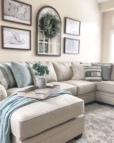 a living room filled with lots of furniture and pictures on the wall above it's couch