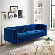 a blue couch sitting on top of a white rug