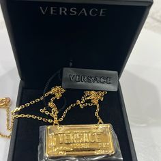 New $450 Versace Gold Tone Brass License Registration Plate Logo Charm Necklace Size(S) Length 59 Cm, About 23" Description New With Tag And Box. Purchased From Versace. Retail $450. Photos Are Of The Actual Item. Authentic Versace Necklace In A Whimsy Style. Gold Tone Brass Curb Chain. Featuring A License Plate Style Print Stating "Versace Forever Italy" And "Spring/Summer 20". Classic Lobster Clasp. Medusa Charm With Versace Hallmark On The Back. Style Dg18036. Made In Italy. Great Collectors Luxury Silver Chain Necklace With Logo Charm, Luxury Gold Chain Necklace With Logo Plaque, Luxury Evening Necklaces With Chain Detail, Luxury Gold Chain Necklace With Logo, Luxury Evening Necklace With Chain Detail, Luxury Evening Necklace With Chain, Formal Gold Necklace With Gold-tone Logo Plaque, Formal Gold Chain Necklace With Logo Charm, Gold-tone Logo Plaque Pendant Necklace As Gift