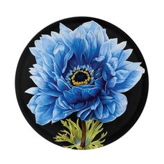 a blue flower painted on a black plate