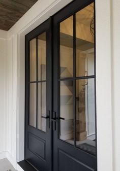 a black double door with glass panels on the front and side doors are open to let in light