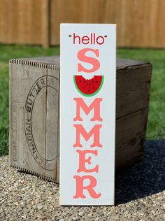 a wooden sign that says hello summer with a slice of watermelon on it