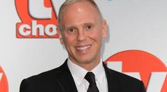 a man in a suit and tie posing for a photo at the tv choice awards