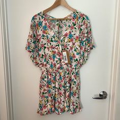 Never Worn- Listicle Flower Print Romper In Size Small. Has Pockets! Lined In Front And In The Shorts. Elastic Waist, Small Button In Front And Ties In Back. Summer V-neck Jumpsuits And Rompers With Floral Print, Summer Floral Print V-neck Jumpsuits And Rompers, Summer Jumpsuit With Floral Print And V-neck, Casual Floral Print V-neck Jumpsuits And Rompers, White Jumpsuits With Elastic Waistband For Vacation, White Relaxed Fit Jumpsuit For Spring, Spring Multicolor Floral Jumpsuits And Rompers, Pink Floral Print Jumpsuits And Rompers With Short Sleeves, Pink Floral Print Short Sleeve Jumpsuits And Rompers