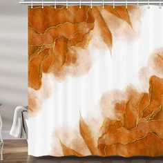 a shower curtain with an orange and white painting on it's side, hanging in a bathroom