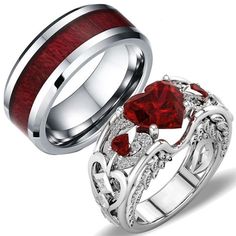 two rings with red and white stones on them, one has a heart shaped stone in the center