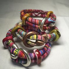 Serape Cord Hook Bracelet.  Designed to look tribal, these bracelets brings to mind Mexican Blankets and ponchos. The colorful fabric calls out of happiness and celebration!  Silver and Brass 5mm hook clasp and ceramic spacer beads.  I LOVE serapes!  The Green One Is 9 Inches.  The Maroon One Is 8 1/2 Inches.  The Pink One Is 9 Inches  If you need a different size send me a message and I will see what I can do. Artisan Beaded Multicolor Wrap Bracelet, Artisan Multicolor Beaded Wrap Bracelet, Hippie Multicolor Beaded Wrap Bracelet, Adjustable Colorful Bohemian Beaded Bracelets, Colorful Adjustable Bohemian Beaded Bracelets, Adjustable Multicolor Artisan Wrap Bracelet, Multicolor Hippie Wrap Bracelet For Beach, Festival Artisan Wrap Bracelet With Colorful Beads, Bohemian Multicolor Wrap Bracelet For Beach