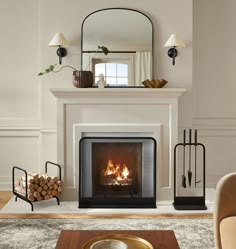 a living room with a fire place in the center and mirror on the wall above it