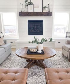 a living room with two couches and a coffee table in front of a fireplace