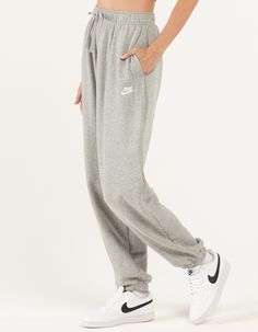 NIKE Sportswear Club Womens Oversized Fleece Sweatpants - HEATHER GRAY | Tillys Nike Comfortable Sweatpants With Elastic Waistband, Nike Relaxed Fit Sweats With Elastic Waistband, Nike Athleisure Sweats With Relaxed Fit, Nike Comfortable Sweats With Elastic Waistband, Nike Relaxed Fit Athleisure Sweats, Comfortable Nike Sweatpants With Ribbed Waistband, Comfortable Nike Sweats With Elastic Waistband, Nike Sweats With Comfort Waistband For Loungewear, Gray Fleece Bottoms For Loungewear