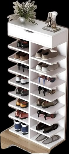 a white shoe rack with many pairs of shoes on top of it and a potted plant in the middle