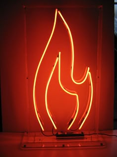 a red neon sign sitting on top of a table