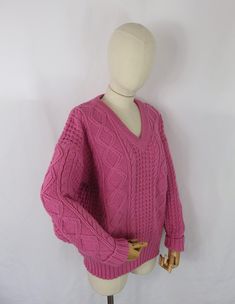 A vintage chunky cable knit sweater in a bubblegum pink tone featuring a v neck.  Size: 16 18 UK Large Bust: 44" Shoulder to hem: 25" Collar to rolled cuff: 26" (unrolled 28") Pit to rolled cuff: 17" (unrolled 19" She is in lovely condition and comes from a smoke free home.  Please take a look at our collection of quirky and unique vintage knitwear. Cozy Pink V-neck Sweater, Pink Oversized V-neck Sweater, Oversized Pink V-neck Sweater, Pink Long Sleeve V-neck Sweater, Pink V-neck Sweater For Winter, Pink Long Sleeve Cable Knit Sweater, Cozy Pink Cable Knit Sweater, Winter Cable Knit Pink Sweater, Winter Pink Cable Knit Sweater