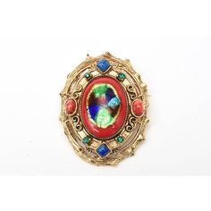 This is part of Chairish’s Costume Jewelry assortment.  This vintage set of signed Hattie Carnegie enamel clip on earrings and small pin and or pendant is reminiscent of a bygone era of Elizabethan meets byzantine influence. The colors are rich, vibrant and exquisite as are all the details and workmanship. They range from the enamel work of red, royal blue, iridescent blue and green.The rhinestones are green and the glass is red and blue. The play of colors used and the high quality of the ename Antique Gold Brass Brooch, Elegant Multicolor Collectible Brooches, Multicolor Enamel Brooch Jewelry, Victorian Metal Brooch Jewelry, Multicolor Victorian Jewelry For Formal Occasions, Victorian Style Metal Clip-on Jewelry, Victorian Multicolor Formal Jewelry, Victorian Metal Brooch, Red Enamel Brooch Jewelry