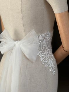 A stunning, elegant statement wedding sash is exquisitely  in beautiful vintage pattern. Your choice tulle  sash ties at the back into a bow. An ultimate luxurious accent piece for your wedding dress or for any special occasion dresses. Color ivory. Cream Wedding Dress With Satin Bow, Elegant Ribbon Bridal Belt For Wedding, Elegant Bridal Belt With Satin Bow For Wedding, Lace Bridal Belt For Ceremony, Elegant White Sashes For Ceremony, White Bridal Belt For Bride, White Wedding Dress With Sashes, Elegant White Ceremony Sashes, Fitted Lace Bridal Belt For Bride