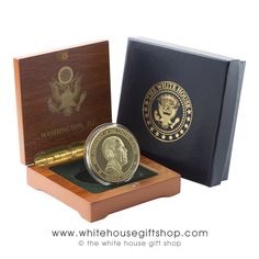 the white house gold proof coin is in its presentation box and it's open