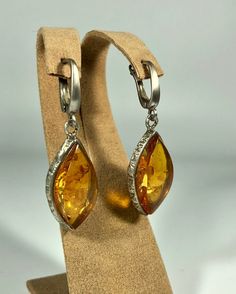 Valentines Day Perfect Gift!Elevate your style with our Handmade Earrings featuring spectacular orange amber set in textured 925 sterling silver. These exquisite earrings are designed for women who appreciate unique and original jewelry. The vibrant orange amber stones are beautifully complemented by the textured silver, creating a stunning and eye-catching piece that adds a touch of elegance and sophistication to any outfit. Product Details: Material: 925 Sterling Silver Stone: Spectacular Oran Orange Teardrop Jewelry For Formal Occasions, Orange Teardrop Jewelry With Matching Earrings, Orange Drop Earrings For Anniversary, Orange Teardrop Anniversary Jewelry, Elegant Amber Jewelry Nickel Free, Amber Drop Jewelry With Matching Earrings, Elegant Amber Earrings With Polished Finish, Amber Teardrop Jewelry With Matching Earrings, Amber Teardrop Pierced Jewelry