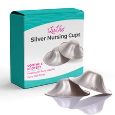 two silver nursing cups sitting on top of a box