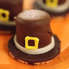 some chocolate candies are sitting on a glass plate with yellow and black trims