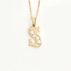 Add a touch of brilliance to your style with our Custom CZ Initial Pendant in 14K Gold. This exquisite piece showcases your chosen initial in dazzling cubic zirconia stones, set in a lustrous 14K gold pendant. Complete it with your charm and elevate your look with a personalized touch of elegance and sparkle. 14k solid gold handcrafted pieces 100% ethical sourced jewelry Material: 14k Solid Gold CZ Quality:Carat Weight: 0.10 ctwColor: F-GClarity: VS2Cut: Excellent Pendant Height: 20 mm / 0.79 in Elegant Cubic Zirconia Initial Necklace Gift, Gold Initial Necklace In Cubic Zirconia, 14k Gold Diamond Necklace With Initial Pendant, Yellow Gold Initial Necklace With Cubic Zirconia, Cubic Zirconia Initial Pendant Necklace, Gift Cubic Zirconia Diamond Necklace With Initial Pendant, Yellow Gold Cubic Zirconia Initial Pendant Necklace, Elegant Yellow Gold Initial Necklace With Cubic Zirconia, Yellow Gold Cubic Zirconia Initial Necklace