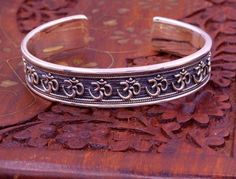 Excellent handmade 925 sterling silver Hindu mantra Aum bracelet, vintage antique stylish unisex gifting oxidized jewelry from Rajasthan india.Metal-925 sterling silver.Type-Bracelet/ kada.Size-Adjustable.Width-1.4 centimeters.Weight-42.470 grams approx.Finish-Oxidized.Stamped-925.Makes excellent gifting for birthday, wedding anniversary, mother's day, father's day Spiritual Toe Ring Jewelry For Festivals, Adjustable Oxidized Jewelry For Ceremonial Occasions, Adjustable Silver Jewelry For Rituals, Adjustable Antique Silver Jewelry For Ceremonial Occasion, Handmade Sterling Silver Bangle In Spiritual Style, Spiritual Bangle With Oxidized Finish As Gift, Bohemian Sterling Silver Cuff Bracelet For Festivals, Adjustable Sterling Silver Cuff Bracelet For Festivals, Spiritual Silver Bangle With Intricate Design