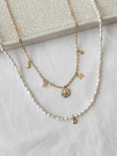 Create your own personalized keepsake charm necklace! This is a custom necklace you will adore for years to come! All charms, chains, and accents, are made with long lasting, non tarnish, and 100% sensitive skin safe 14K Gold Filled with genuine gemstones and freshwater pearls. 🤍HOW TO ORDER🤍 1. Choose Number of Charms, Chain Style, and Chain Length from the drop down menu. 2. Write the name of the charms in the Personalization section below in the order you would like your charms to hang from left to right. You may also include any notes about spacing of the charms in this section as well!  All orders will have centered charms and even spacing unless otherwise specified. Example: Butterfly, Heart, Shell, Rose Quartz 14K Gold Filled Chain Styles: Long Short (1.8mm) Mini Paperclip (2x5mm) White Charms Necklace For Birthday Gift, White Charm Necklace For Birthday, Dainty Customizable Charm Necklace For Birthday, Personalized White Charms Necklaces, Dainty Charm Necklace, Personalized Charm Necklace, Custom Charm Necklaces, Custom Charms, Handmade Charms