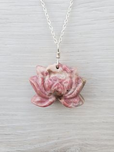 "This pink Rhodonite lotus flower necklace features a carved Rhodonite lotus. Each pink lotus flower is measured approximately 31mm wide and 24mm tall, that is about 1.3\" wide and 1\" tall.  This Rhodonite lotus is drilled, and wire wrapped with solid sterling silver wire. You will receive the exact one as you choose! It is natural pink rhodonite with natural inclusions/other minerals that results in impurities we see in the rhodonite (impurities colors include black, dark green, clear, cream, Pink Gemstone Flower-shaped Jewelry, Nature-inspired Pendant Jewelry For Meditation, Flower-shaped Natural Stone Jewelry Gift, Flower-shaped Natural Stones Jewelry For Gift, Flower Shaped Natural Stone Jewelry Gift, Spiritual Flower Pendant Necklace With Gemstone, Flower Shaped Sterling Silver Jewelry With Natural Stones, Sterling Silver Flower Jewelry With Natural Stones, Spiritual Lotus Flower Jewelry For Meditation