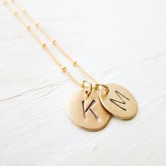 "Delicate and timeless, this sweet necklace features goldfill discs that are stamped with a 1/4\" uppercase arial font initial of your choice. The disc(s) stand alone on 14K goldfill satellite chain. . { m e a s u r e m e n t s } . 1/2\" discs 16 or 18 inches . { o p t i o n s } . Please leave personalization preference in the notes to camileedesigns field at checkout If you would like to add birthstone charms you can do so here: https://www.etsy.com/listing/152899880/add-a-birthstone-gemstone-o 14k Gold Filled Personalized Initial Pendant Charm Necklace, Personalized Initial Pendant Necklace In 14k Gold Filled, Personalized 14k Gold Filled Initial Pendant Necklace, Personalized 14k Gold Filled Initial Necklace, Gold 14k Gold Filled Initials Charm Necklace, Personalized Gold Dainty Coin Necklace, Gold 14k Gold-filled Initials Charm Necklace, Gold Initials Necklace In 14k Gold Filled, Dainty Personalized Gold Coin Necklace