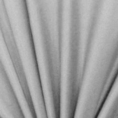 black and white photograph of the back side of a curtain with pleaed fabric on it