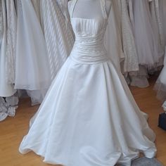 a white wedding dress on display in a store