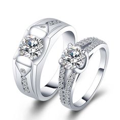 two white gold wedding rings with diamonds on each one and an engagement ring in the middle